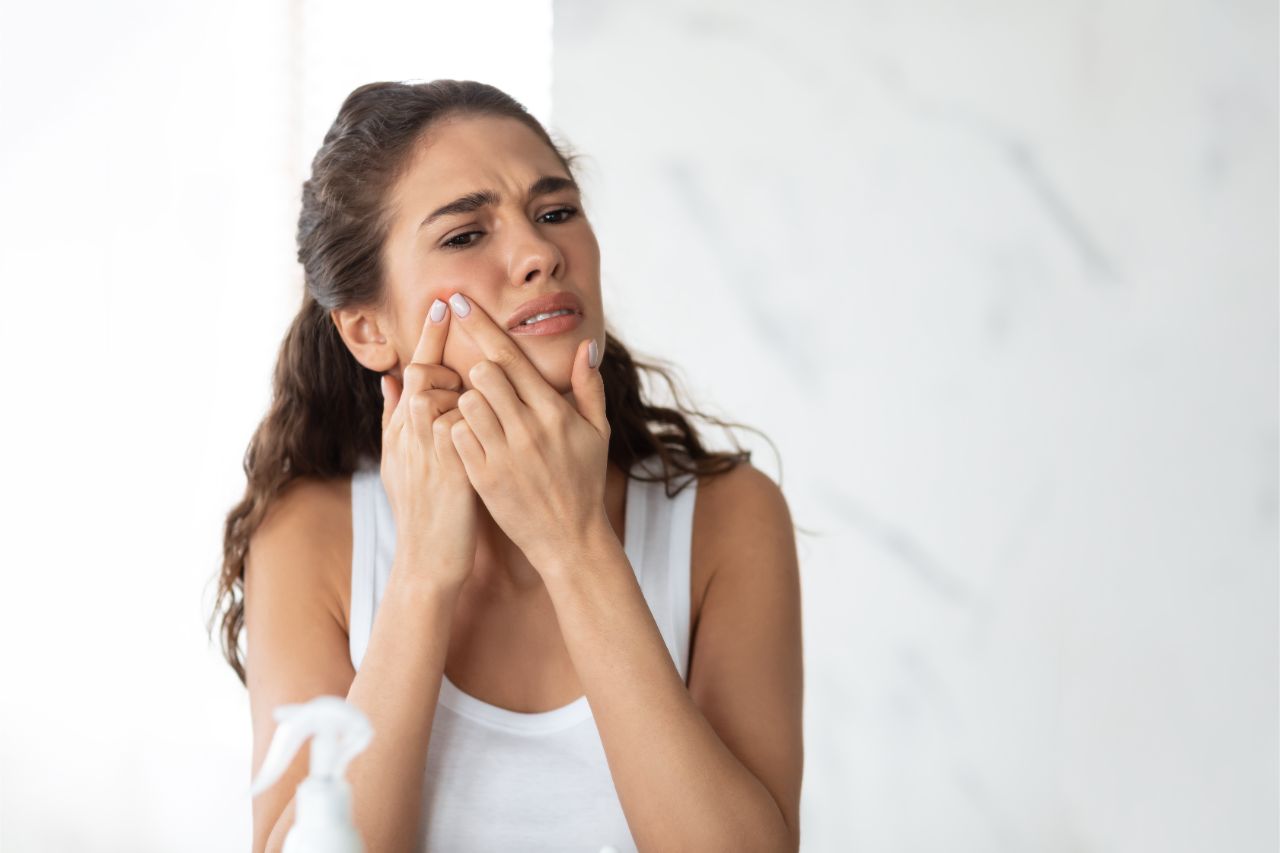 Woman popping pimple