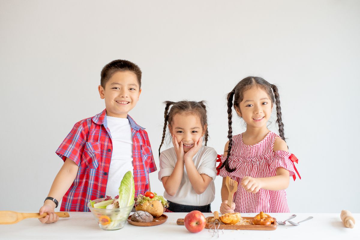 A group of kids standing behind the healty food they eat